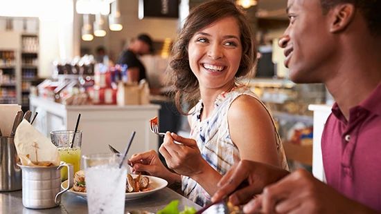 Person Holding Stack of Plates in Commercial Kitchen
